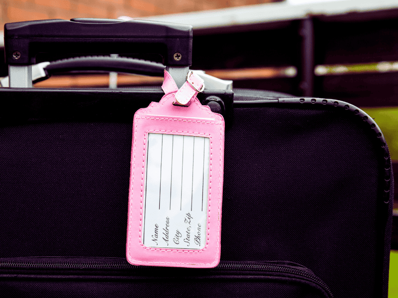 Stylish luggage tag with a thank-you note attached, perfect as a practical and unique baby shower party favor.
