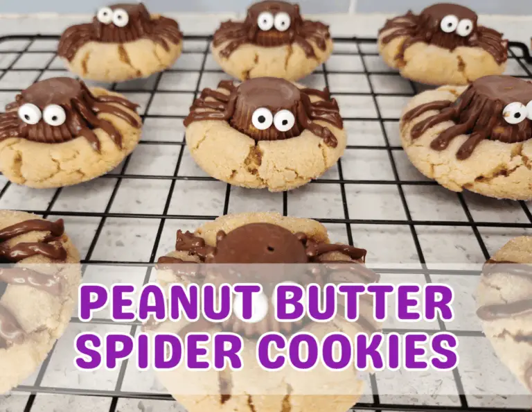 Finished peanut butter spider cookies with candy eyes and chocolate legs cooling on a wire rack, ready to serve for Halloween.