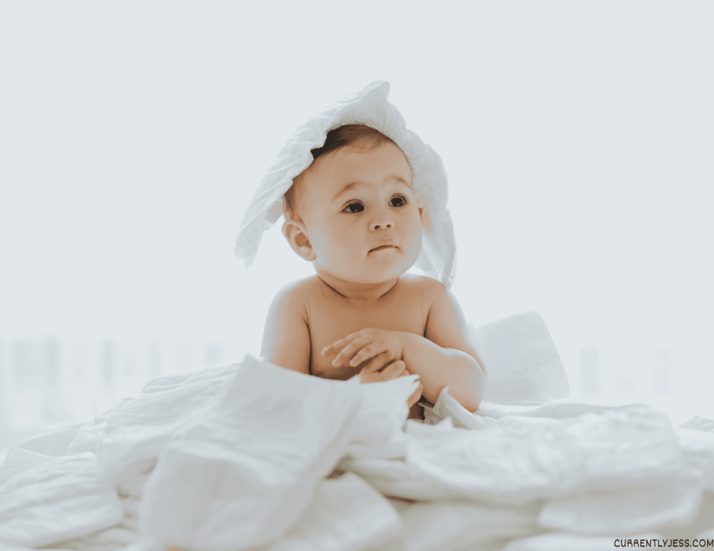Baby with diapers on his head. 