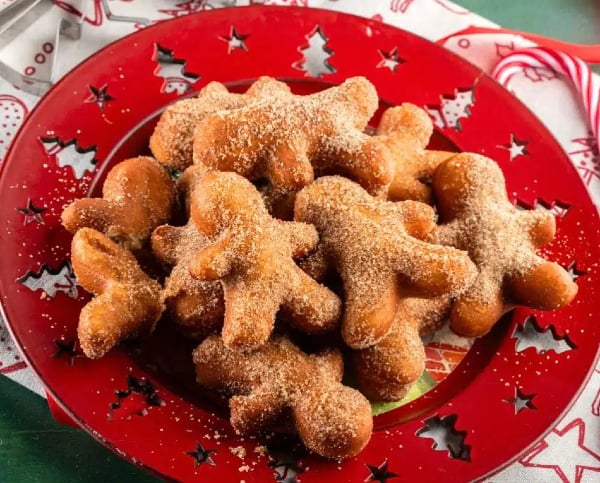 Gingerbread man Christmas donuts fried until golden and coated in spiced sugar, a fun homemade holiday treat full of warm ginger and cinnamon flavor.