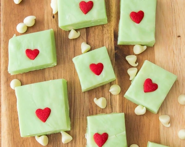 Easy Grinch fudge with red candy hearts, a bright green no-bake Christmas treat for kids.