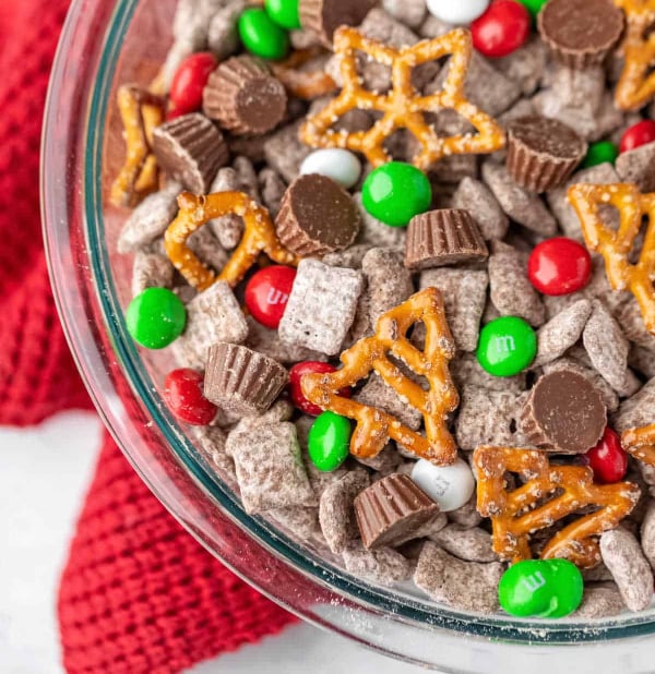 Reindeer chow made with Chex cereal, pretzels, M&Ms, peanut butter cups, and powdered sugar, an easy no-bake Christmas snack mix for kids.