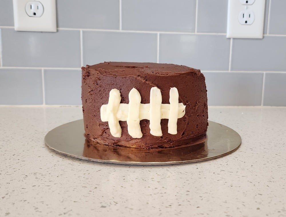 Football decorated smash cake for a First Year Down first birthday party. 